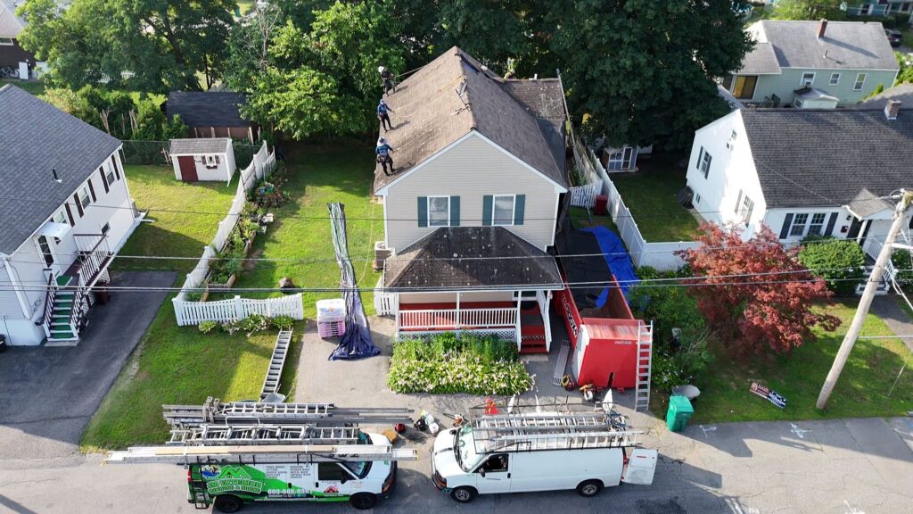 Aerial view of a professional roof replacement in Chelmsford, MA, managed by JM Exteriors' Owens Corning & GAF certified contractors.